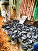 Buckets of coal for sale in Kibera.